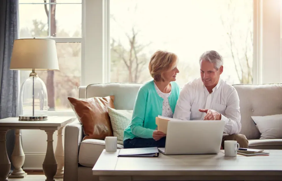 Couple Sat on a Sofa with a Laptop