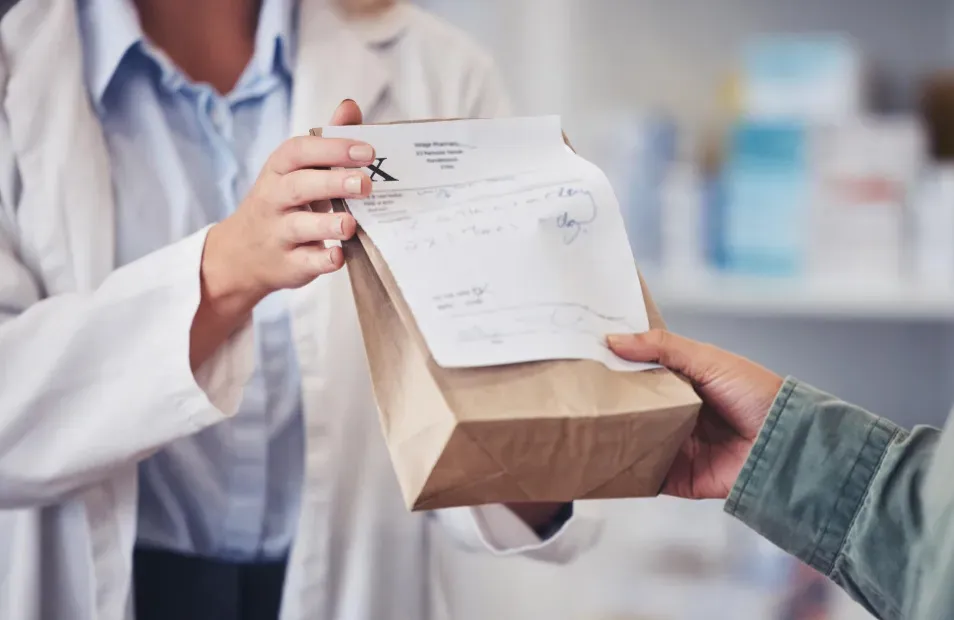 Pharmacist holding a prescription bag